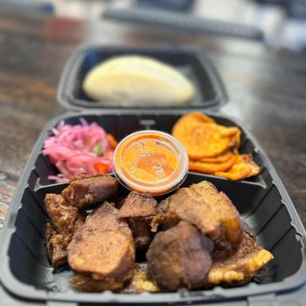 Mr. Jack's Peruvian Rotisserie Chicken meal with fried chicken, pickled onions, sweet potato chips, and sauce.