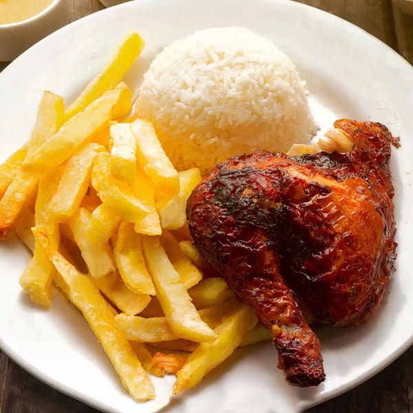 Mr. Jack's Peruvian rotisserie chicken leg and thigh, with a side of fries and white rice.