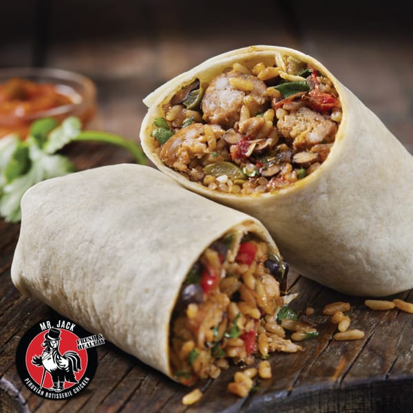 Two Mr. Jack Peruvian Rotisserie Chicken burritos, filled with chicken, rice, and vegetables, on a wooden surface.